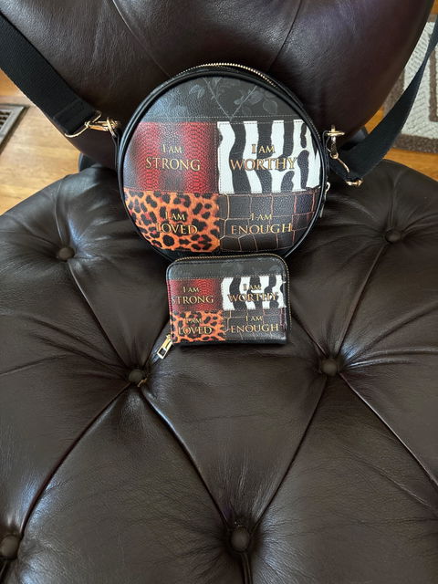 Customer photo: the Kadia circle crossbody bag and matching wallet on a leather chair