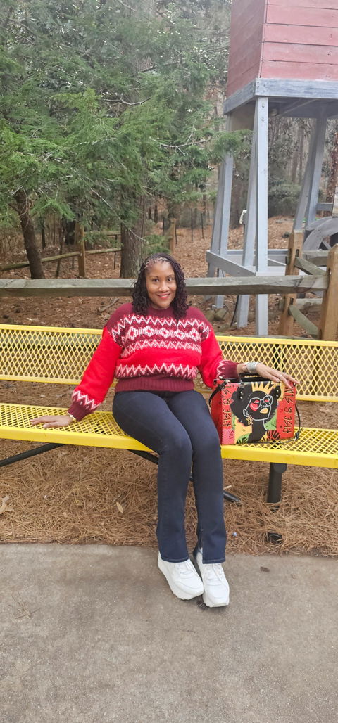 Customer photo: a woman on a bench with her Afroyla handbag