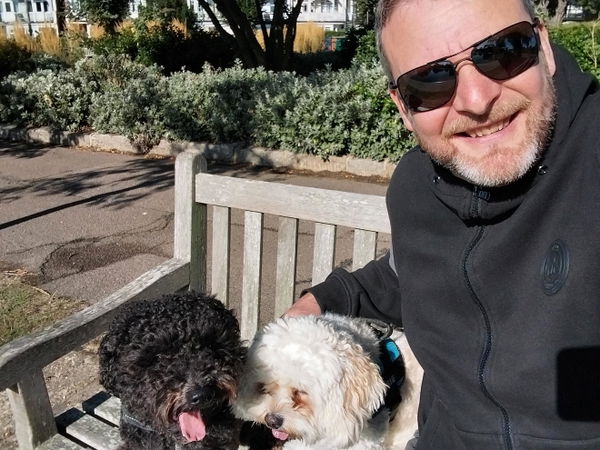 Man wearing Oakley sunglasses with his dogs