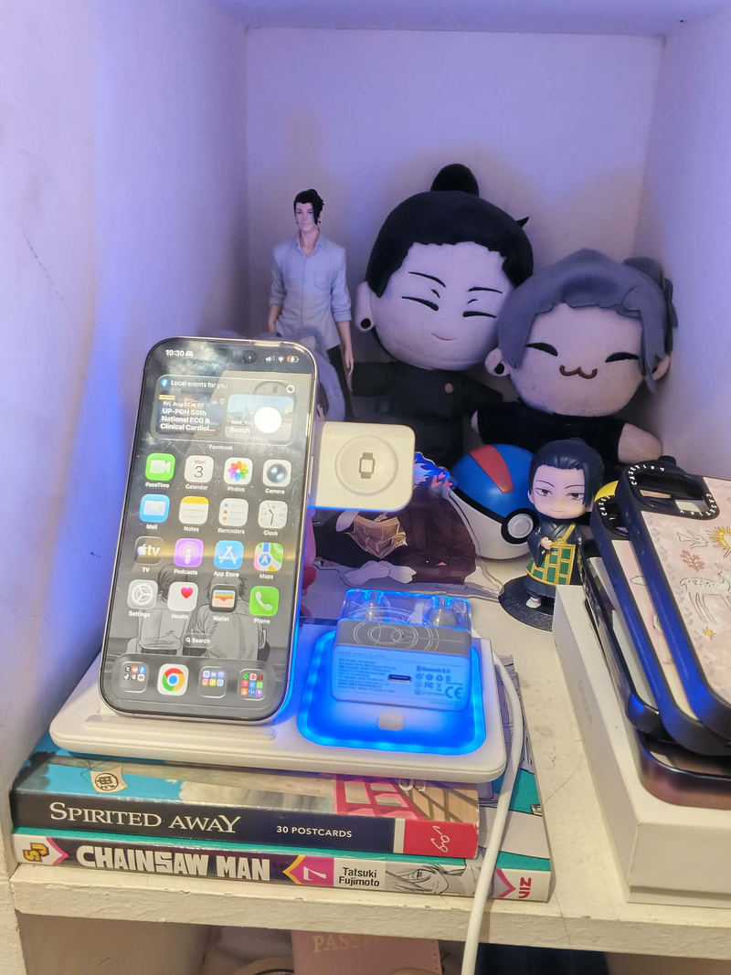 Jean R.'s photo: a phone charging on the 3-in-1 stand inside a shelf nook, with plushies keeping watch