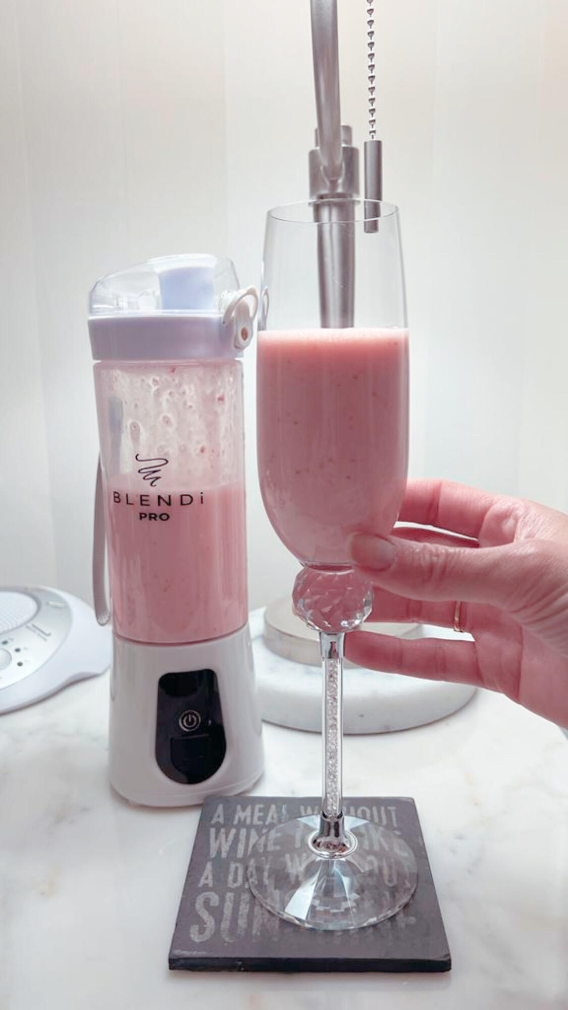 Customer photo of a white Pro+ and a strawberry smoothie poured into a glass