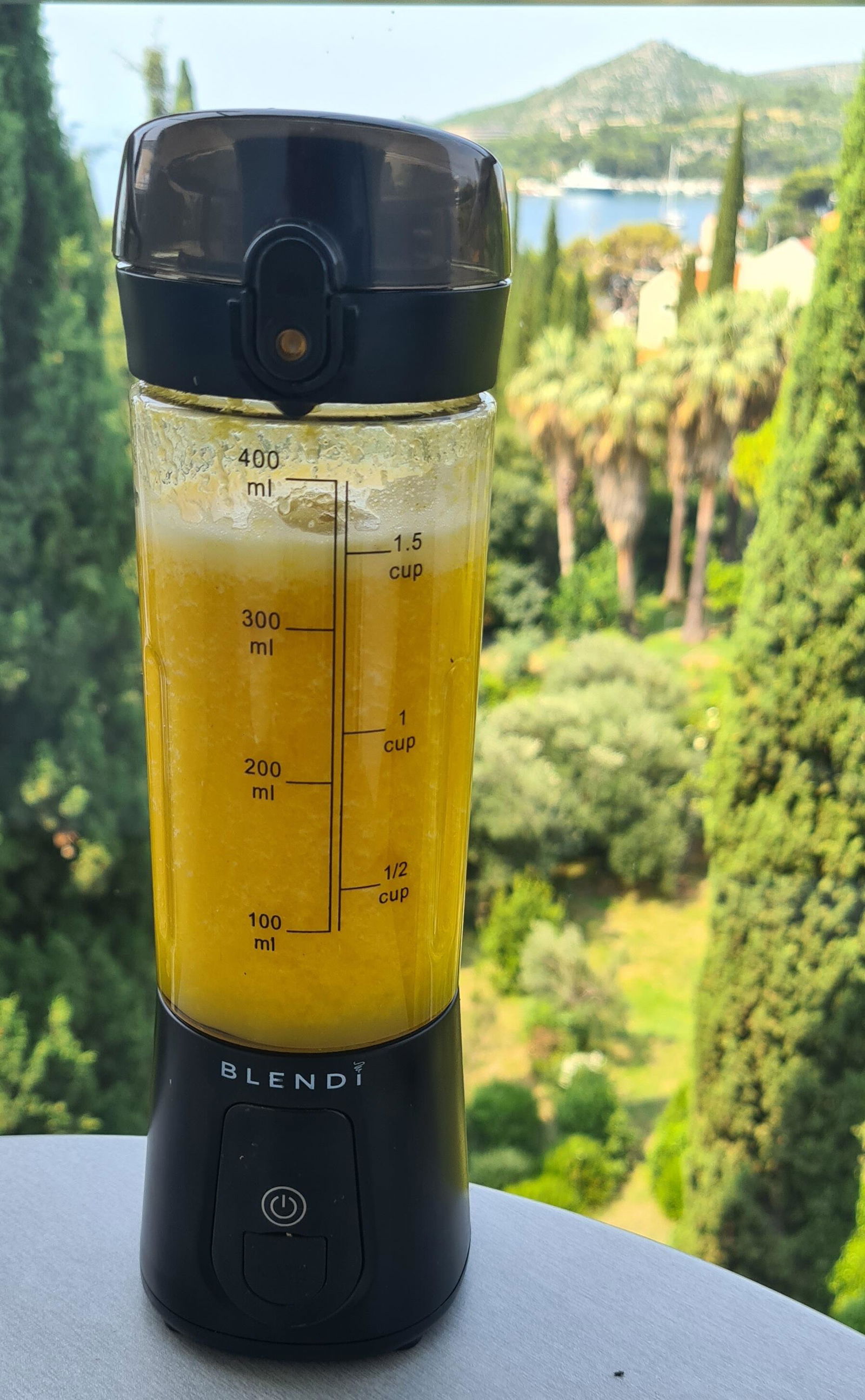 Customer photo of a black Pro+ with a mango smoothie outdoors