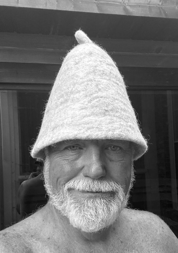 Customer wearing his Cult of Sauna hat outside his sauna