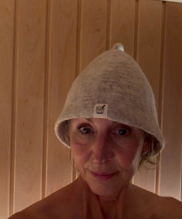 Customer wearing her Cult of Sauna hat in her sauna