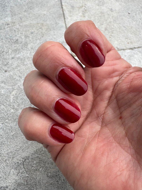 Louise’s hand with deep red Dazzle Dry nails after four hours of gardening