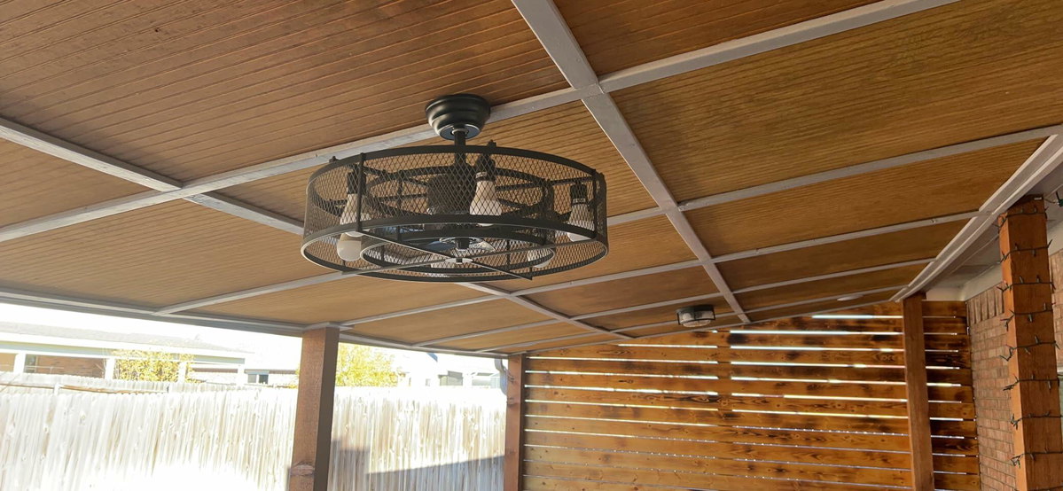 Customer-installed 26-inch caged ceiling fan on a covered porch