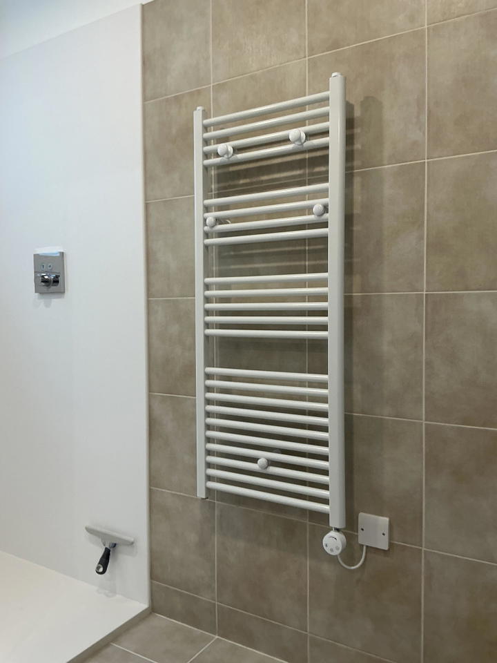 Customer photo: 1200 x 500 white electric rail installed in a bathroom