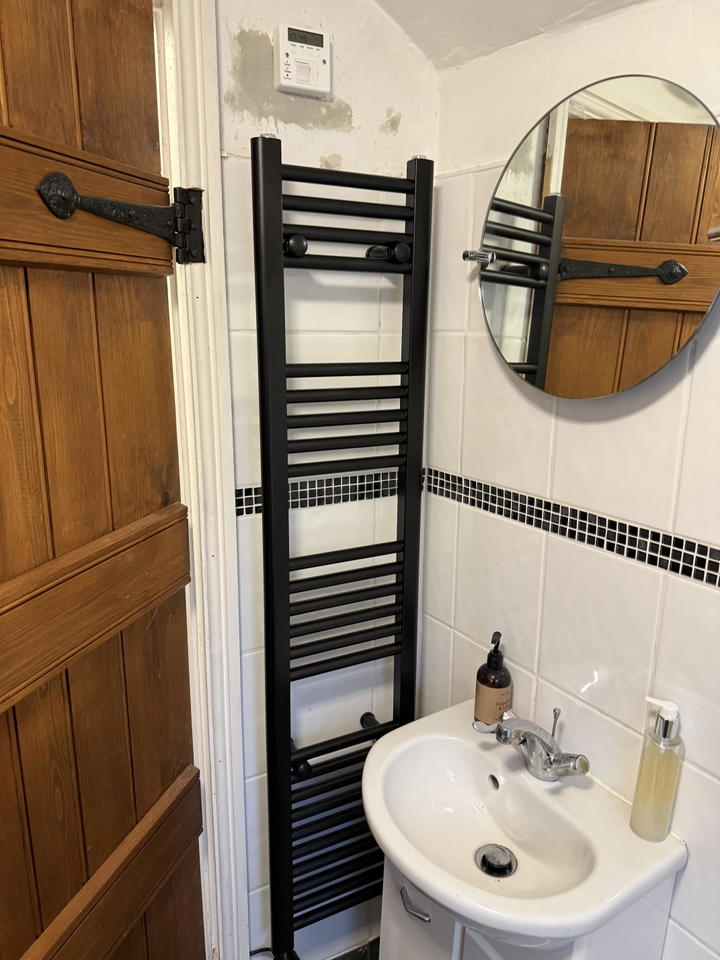 Customer photo: 1400 x 300 black electric rail installed in a bathroom
