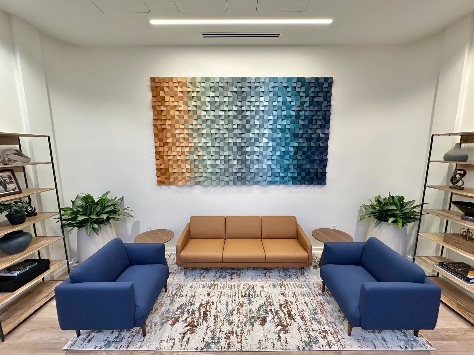Coastal Dream geometric wood wall art above a tan sofa in Rose’s room.