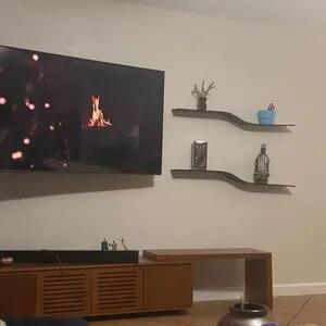 Customer photo of a wenge floating wall shelf holding books