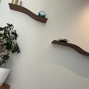 Customer photo of walnut floating wall shelves in a hallway