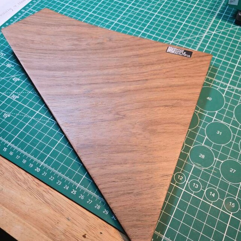 Customer photo of a wooden corner shelf with a curved edge