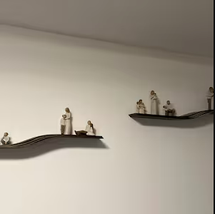 Customer photo of a curved wooden floating wall shelf