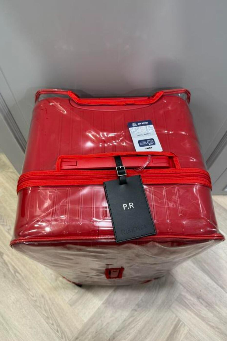 Ian's review photo of a clear Rimowa Essential Trunk Plus cover with red trim