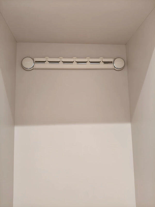 A renter's entryway with a backpack on the door hook