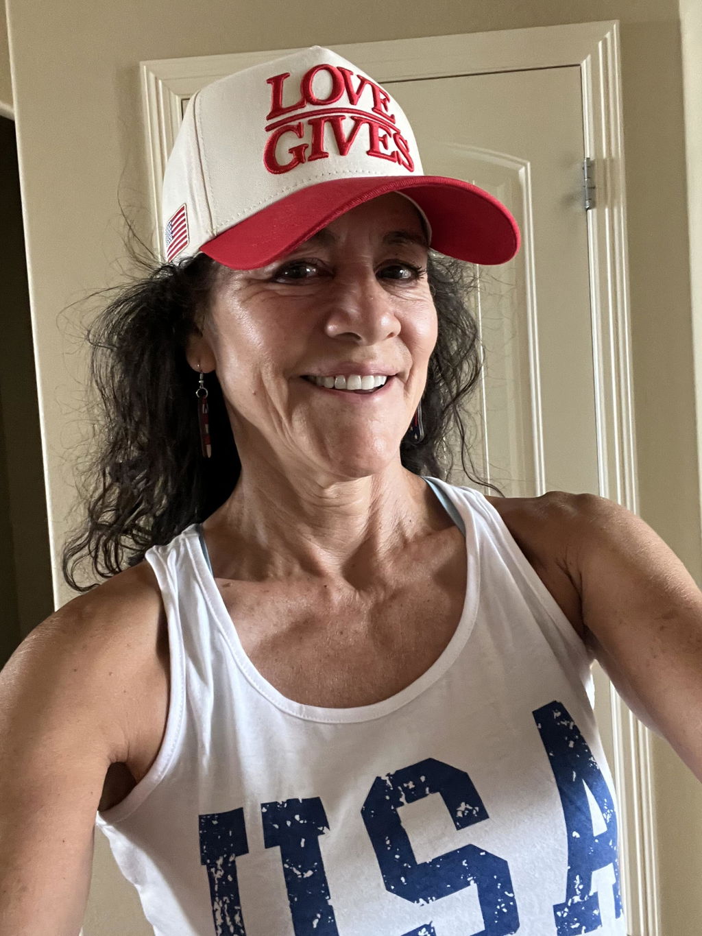 Customer in a Cherry Red USA LOVE GIVES hat