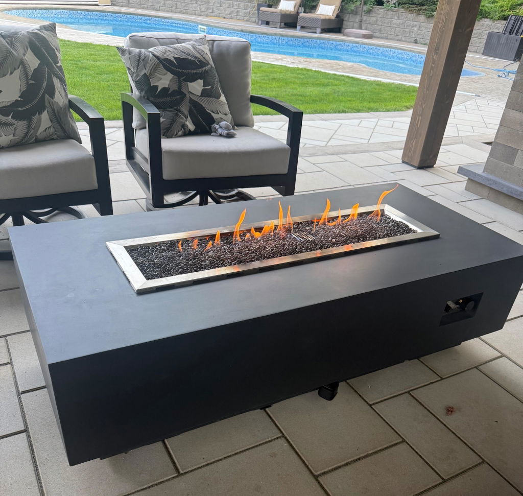Derek’s outdoor space with a lit fire table on a paved patio