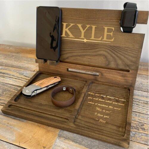 Customer photo of the Wooden Charging Dock with Custom Message personalized gift from Groovy Guy Gifts, shared in a five star review by Toni D.