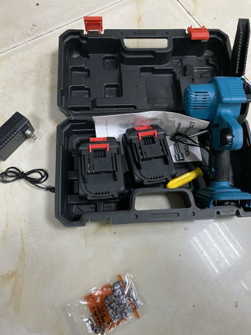 Customer holding cordless chainsaw