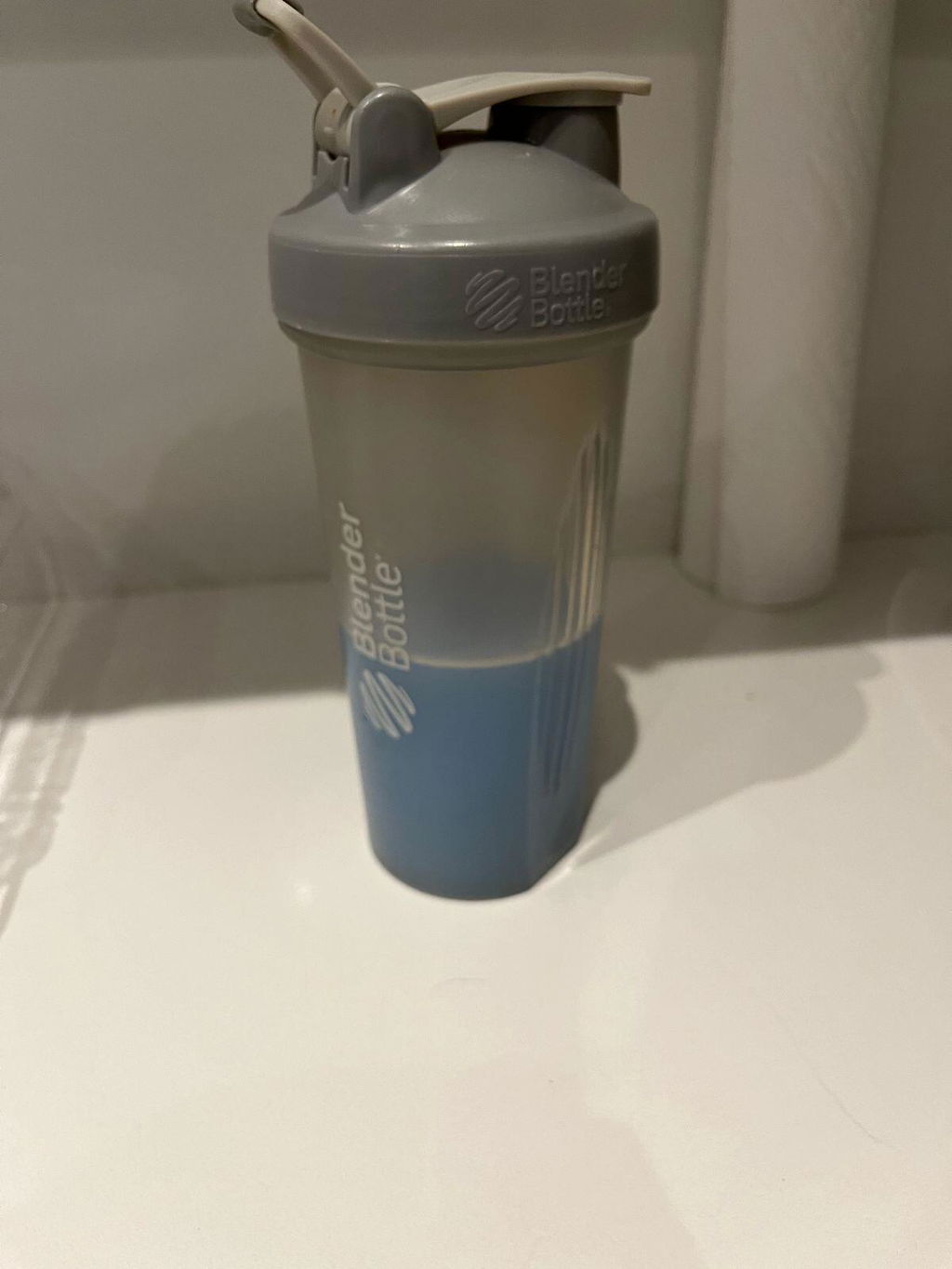 Customer review photo of a gray shaker containing a prepared blue Protein Hydrator drink