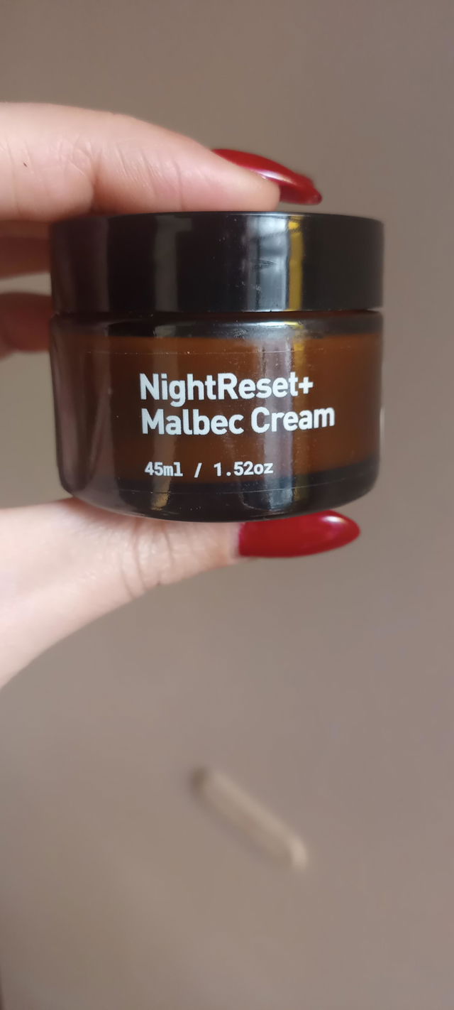 Frasco de Night Reset Malbec Cream en la mano, foto subida con la reseña