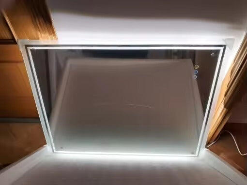 Customer photo of a rectangular mirror lit up before installation