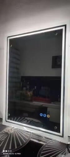 Customer photo of an illuminated rectangular mirror standing upright before installation