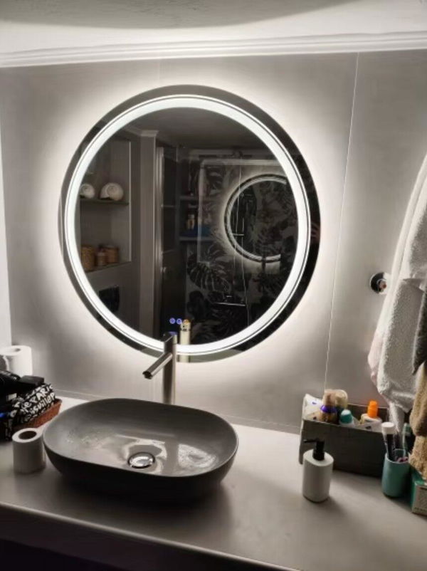 Customer photo of a round double light mirror above a dark basin