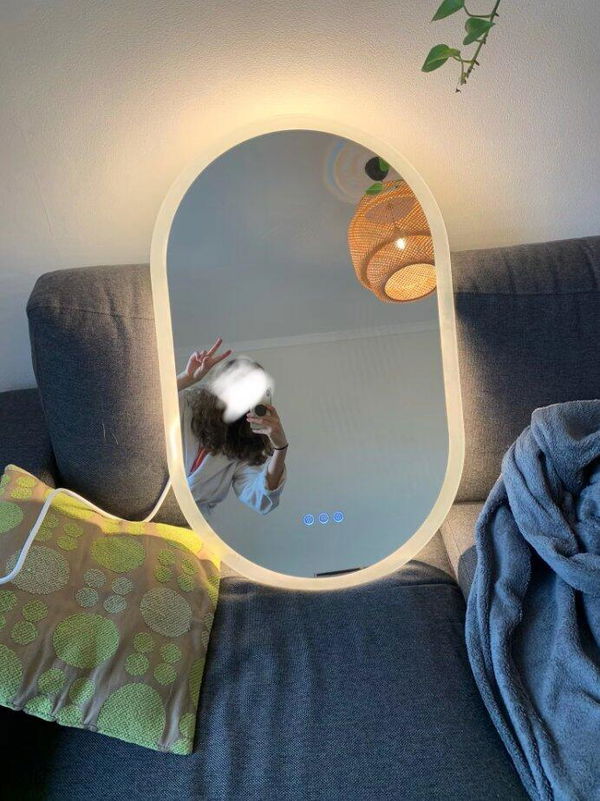 Customer photo of an oval mirror with its backlight switched on before installation