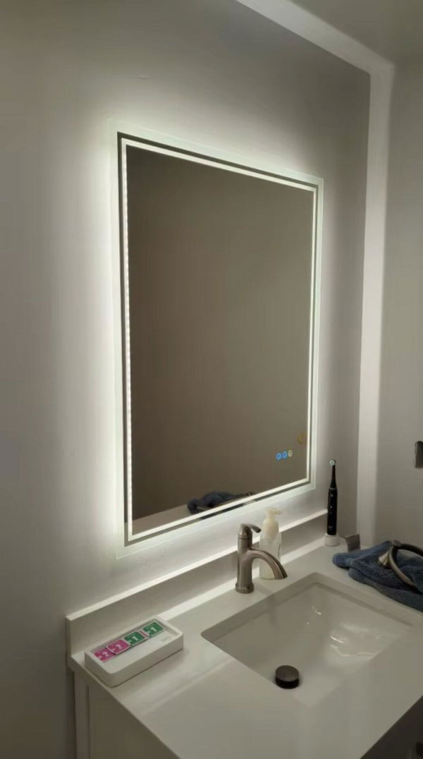 Customer photo of a rectangular backlit mirror above a white bathroom basin