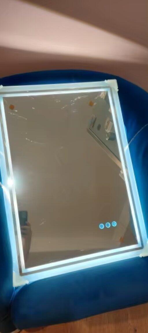 Customer photo of a rectangular mirror illuminated while resting on a chair