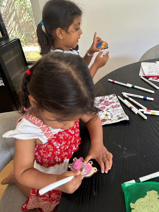 Two children painting together at home