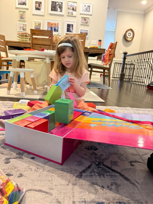 A child painting at the kitchen table