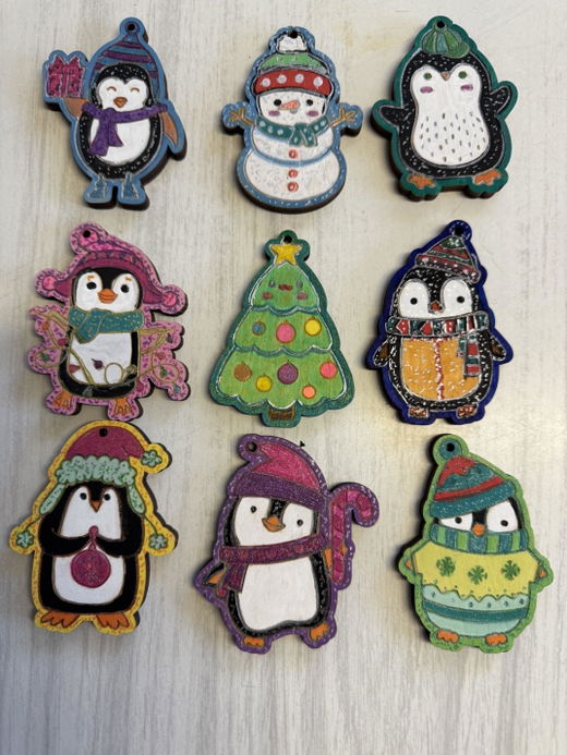 Nine painted ornaments laid out on a table