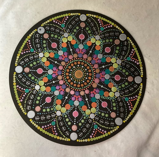Dot mandala painted on black by a customer