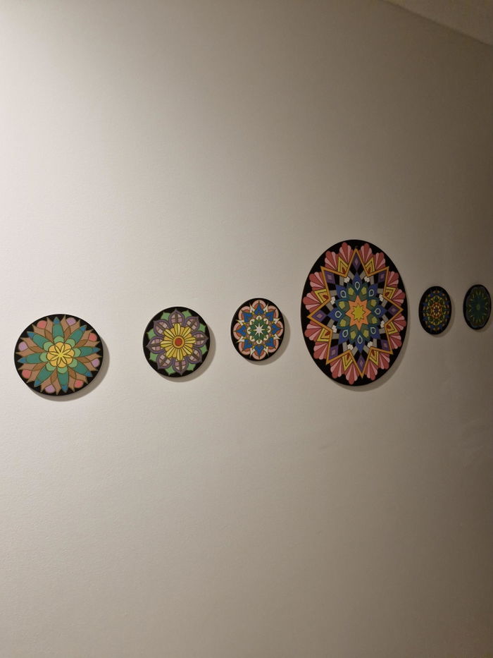 Finished painted boards displayed on a wall