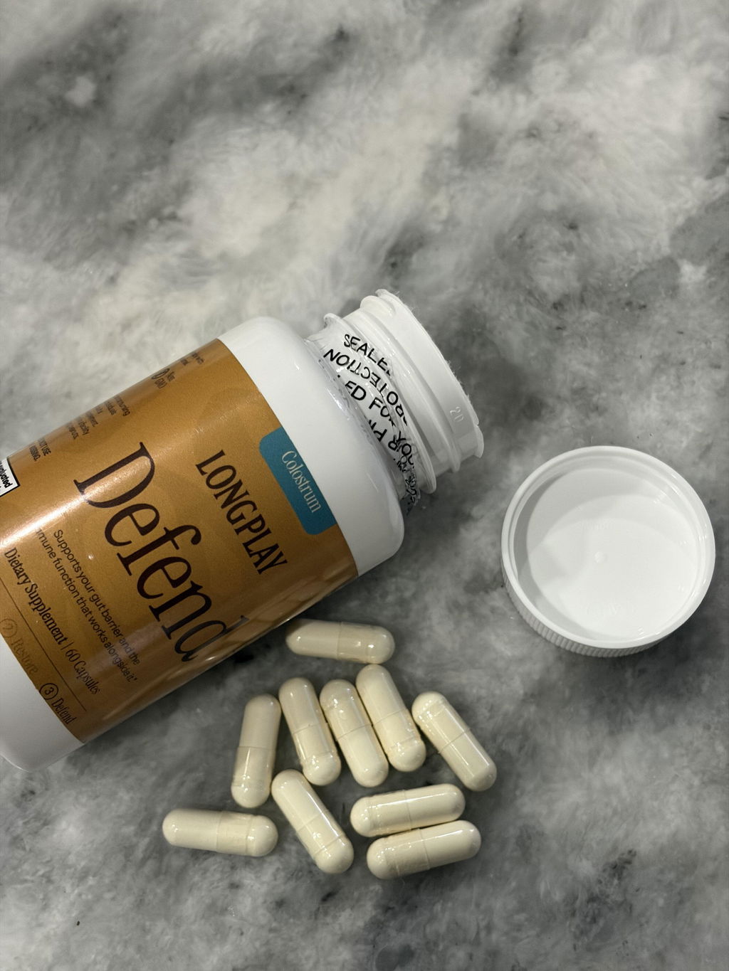 Customer photo of an opened bottle of Longplay Defend colostrum capsules