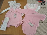 Pagliaccetto neonato in cotone pompon con voulant