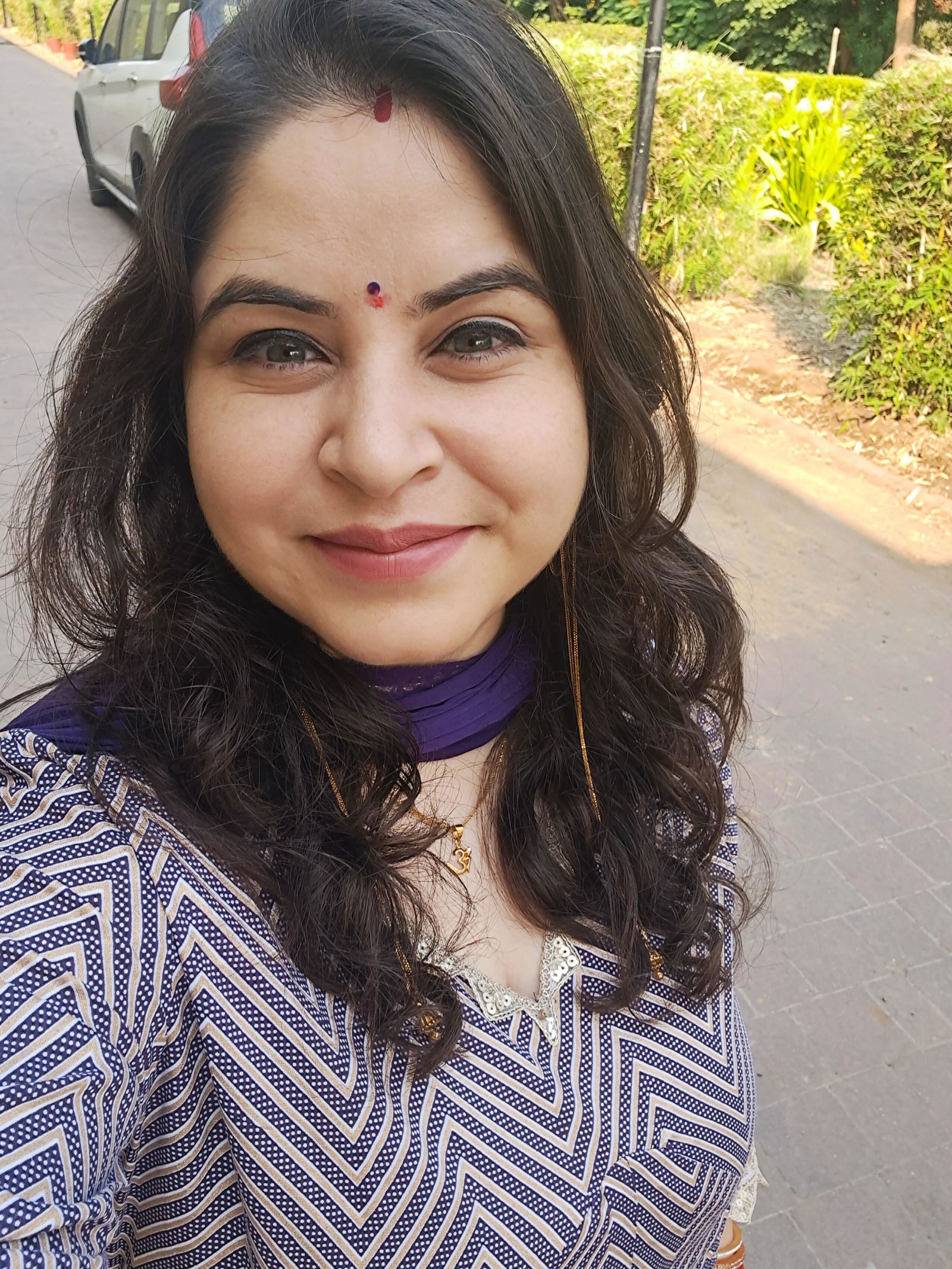 Priya smiling, wearing the Signature Sindoor