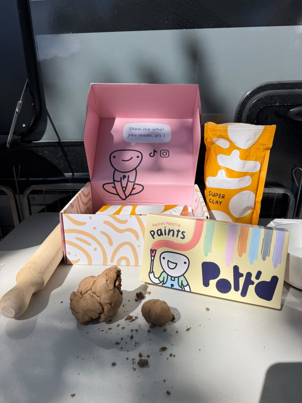 Kit box surrounded by finished clay pieces