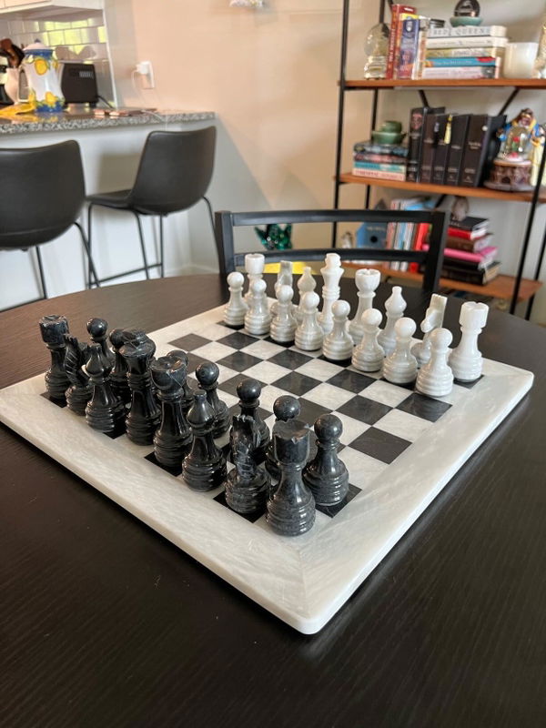 Customer photo of a white and black marble chess set on a table