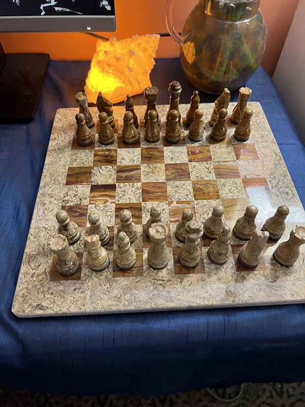 Customer's marble chess set displayed on a home desk
