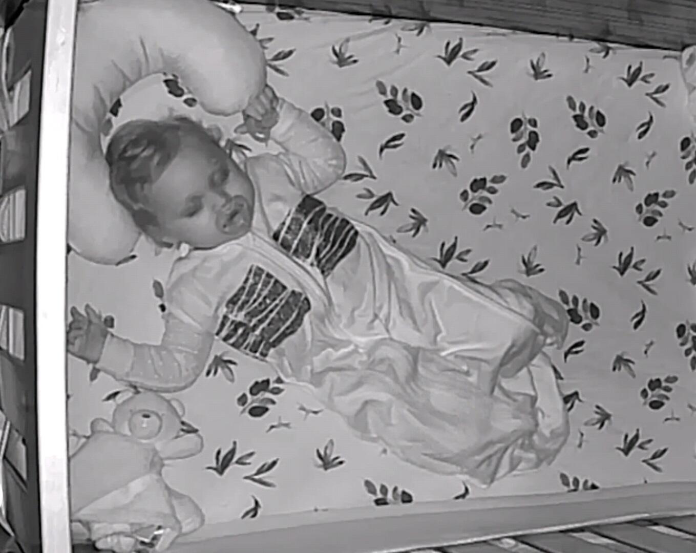 Baby wearing the Sleep Sack seen on a night monitor
