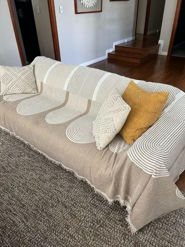 Customer photo from Jesenia Fondeur showing the Geometric Wave Couch Blanket on their sofa