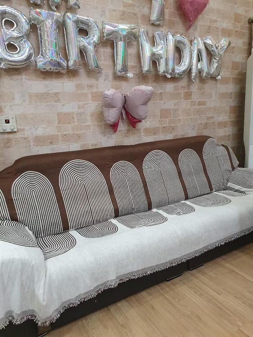 Customer photo from Cherry showing the Geometric Wave Couch Blanket on their sofa