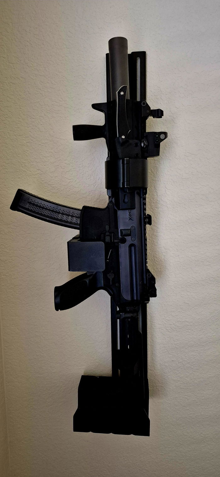 An owner's SIG MPX SBR with a suppressor and an optic locked in a RACT