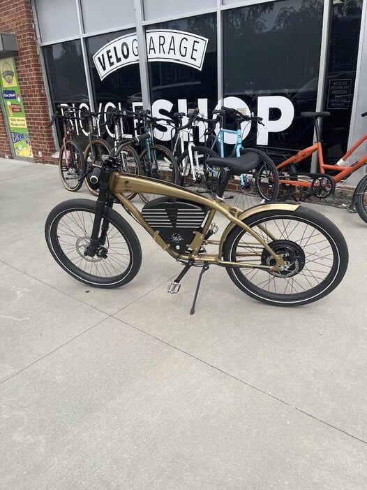 John’s Gold Shelby parked outside a bicycle shop