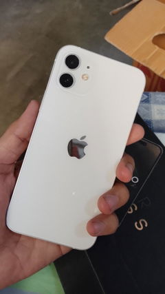Buyer’s photo: back of a white iPhone 12, held in hand