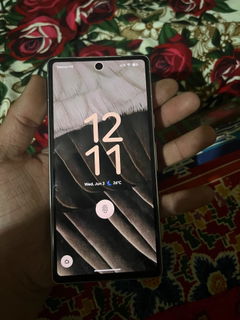 Buyer’s photo: Pixel 7a lock screen, held in hand