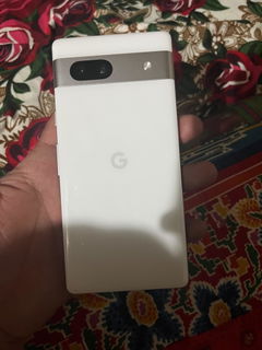 Buyer’s photo: back of a white Pixel 7a, held in hand